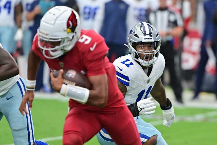 Sep 24, 2023; Glendale, Arizona, USA; Arizona Cardinals quarterback Joshua Dobbs (9) escapes a tackle from Dallas Cowboys linebacker Micah Parsons (11) in the first half at State Farm Stadium. Mandatory Credit: Matt Kartozian-USA TODAY Sports